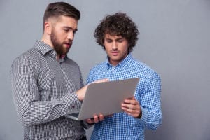 Two Men Have Found Something Interesting On A Laptop