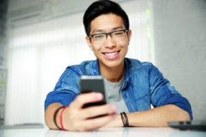 man texting and smiling