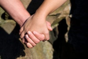 a closeup of a man and woman holding hands BK9VRF0Si