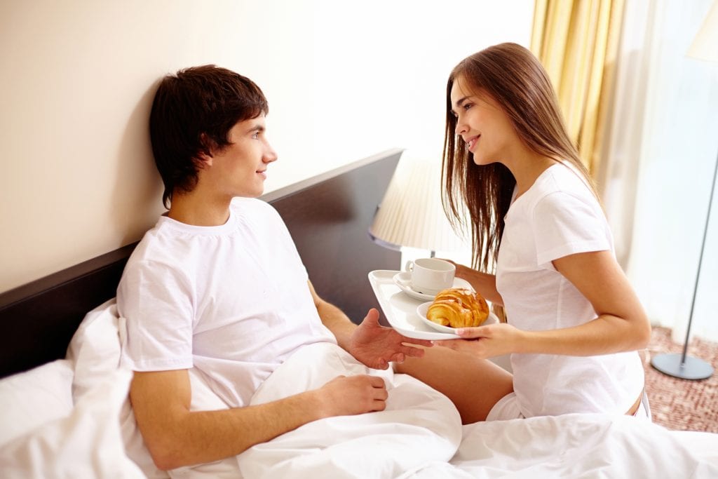 couple having breakfast in bed