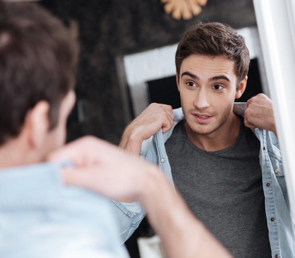 man looking at himself in the mirror