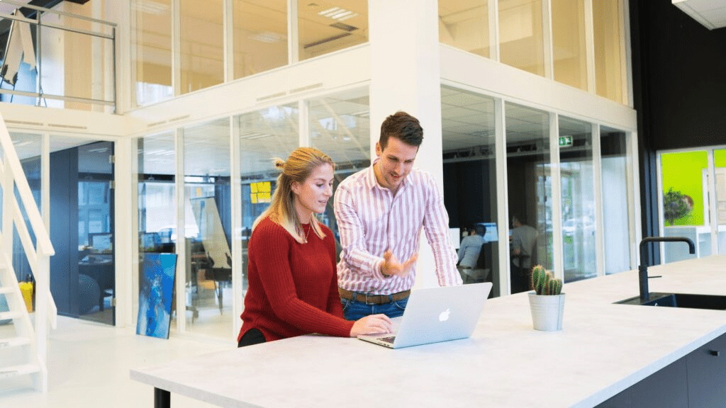 photo of a man and woman using a laptop computer