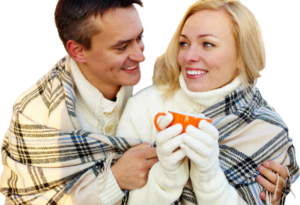 man giving woman coffee on a cold winter day