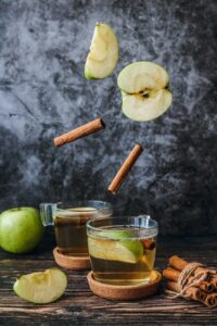 photo of slice green apple and cinnamon stick