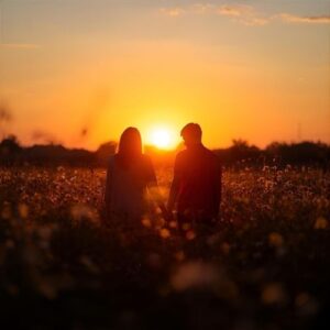happy couple walking hand-in-hand in a meadow