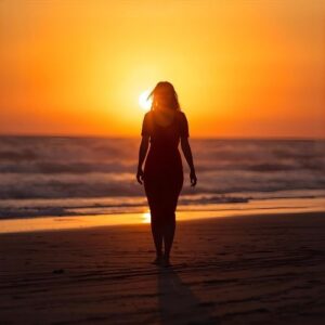 Sunset silhouette of woman walking away calmly, representing strength and closure