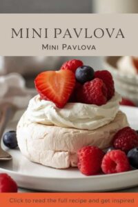 image of mini pavlova with whipped cream, strawberries, raspberries, and blueberries,