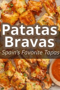 Patatas bravas topped with spicy sauce and aioli.