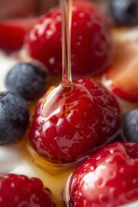 closeup image of yoghurt with honey and berries,