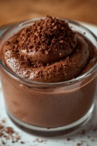 closeup image of chocolate mousse served in a glass,