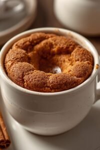 closeup image of cinnamon mug cake served in a mug,
