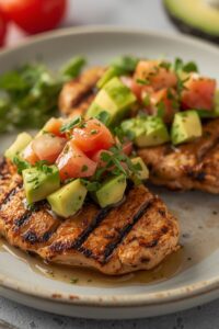 an image of grilled chicken with avocado salsa,
