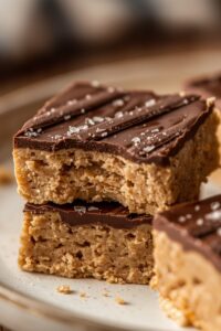 closeup image of no-bake peanut butter bars served on a plate,