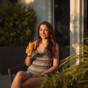 Healthy Smoothies for Women: Every Phase of Your Menstrual Cycle 8 image of a woman enjoying a smoothie outdoors,